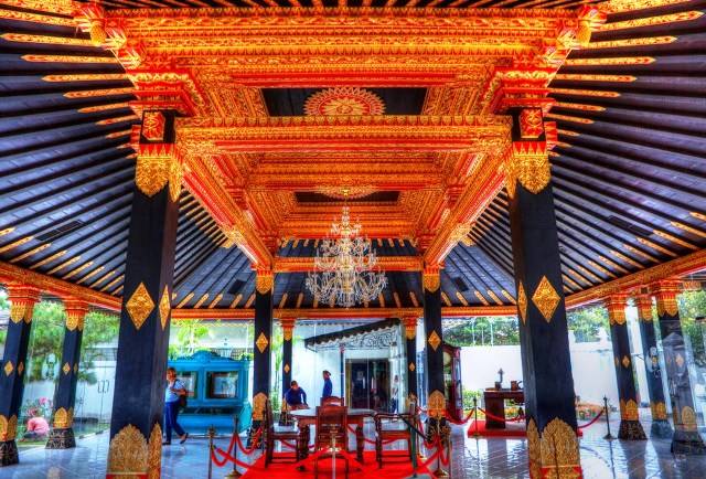 The ornate entrance of the Kraton Yogyakarta Sultan Palace, showcasing grand white pillars and traditional architecture that reflects the royal Echoes of Java Journey.